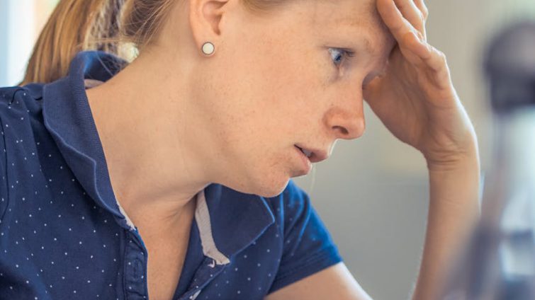 woman sitting in front of the laptop computer in shallow photo