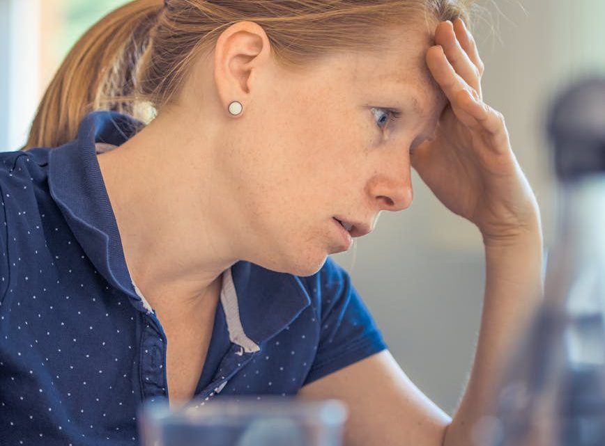 woman sitting in front of the laptop computer in shallow photo